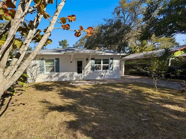 a view of a house with a backyard