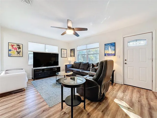 a living room with furniture and a flat screen tv