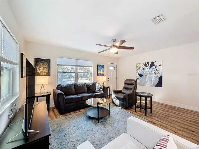 a living room with furniture and a large window