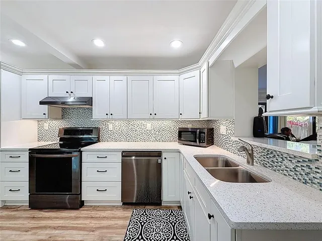 a kitchen with a cabinets and white appliances