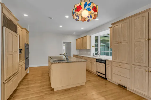 a kitchen with sink cabinets and wooden floor