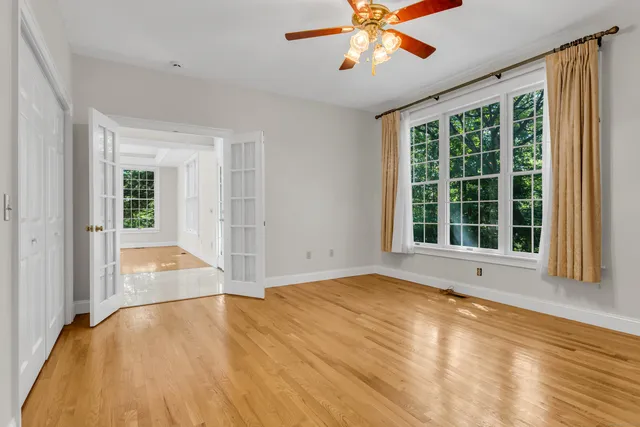 a view of a hallway with wooden floor and entryway