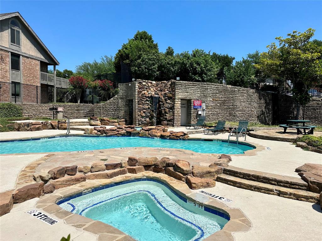 927 Signal Ridge Place Rockwall, TX 75032 - Photo 16 of 16 Resort-style pool with integrated spa and rock-faced waterfall feature