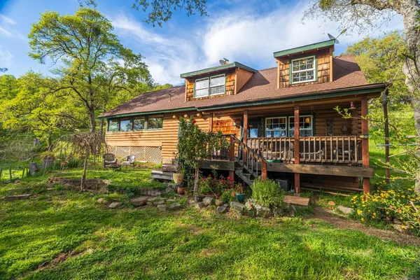 a front view of house with yard and green space