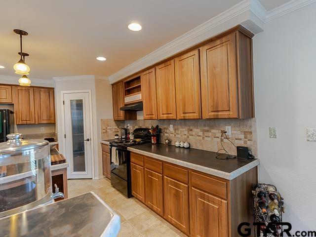 495 Wilcox Drive Rusk, TX 75785 - Photo 18 of 37 a kitchen with stainless steel appliances granite countertop a stove a sink dishwasher and a refrigerator with wooden floor