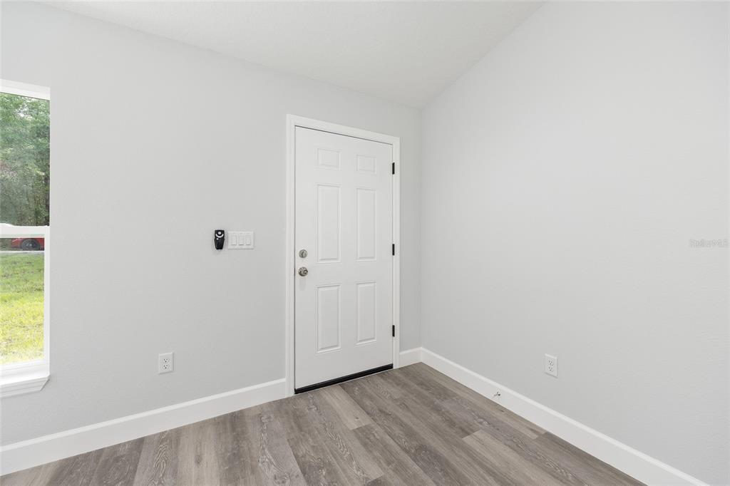 2130 Southwest 159th Court Ocala, FL 34481 - Photo 5 of 27 a view of an empty room with wooden floor and a window