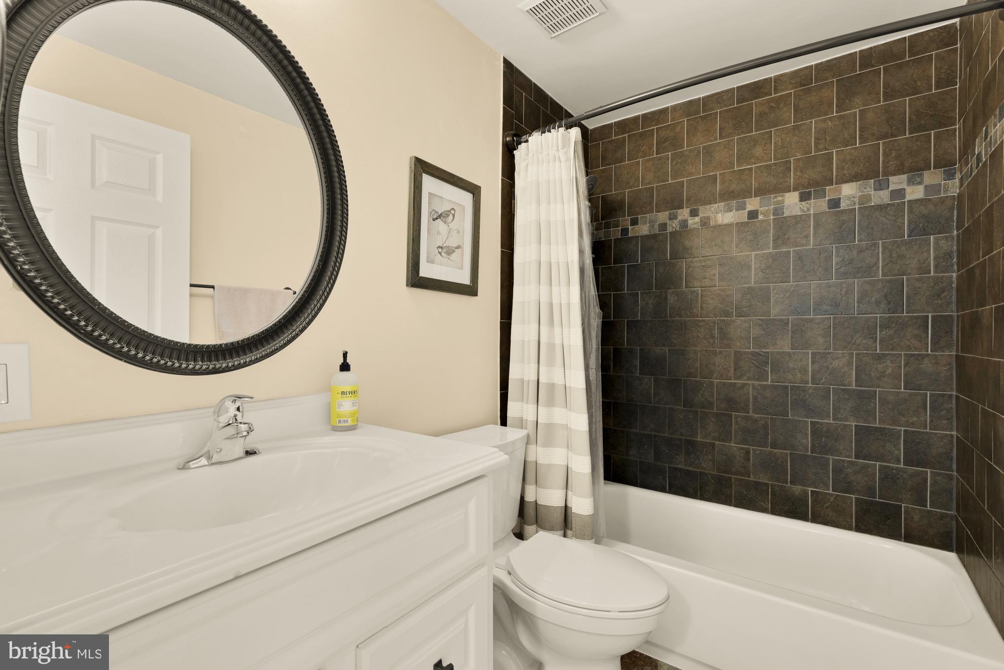 8100 Loving Forest Court Springfield, VA 22153 - Photo 24 of 33 a bathroom with a sink a toilet and a mirror