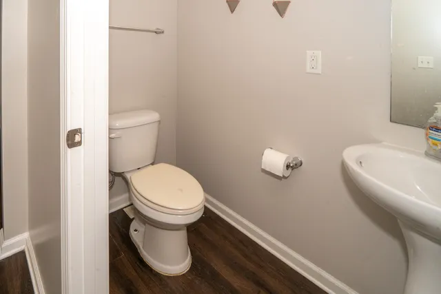 a white toilet sitting next to a white sink