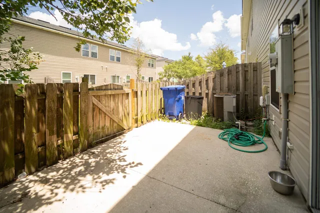 a view of a brick house with many windows and a yard