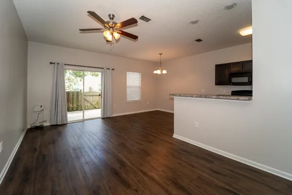 a view of an empty room with a window and a flat screen tv