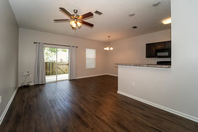 a view of an empty room with a window and a flat screen tv