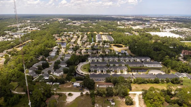 an aerial view of a house with a swimming pool and outdoor seating