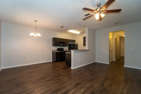 a view of a kitchen with a sink a kitchen microwave and refrigerator