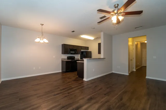 a view of a kitchen with a sink a kitchen microwave and refrigerator