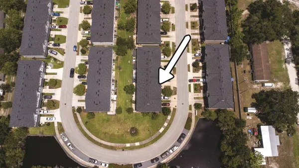 an aerial view of residential house with outdoor space and swimming pool
