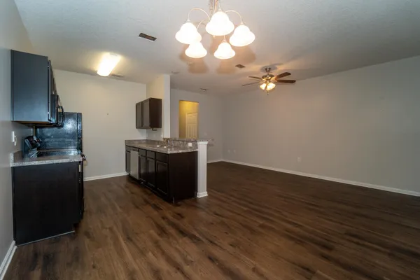 a kitchen with stainless steel appliances a stove refrigerator and microwave