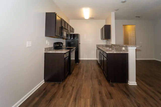 a kitchen with stainless steel appliances granite countertop a stove and a refrigerator