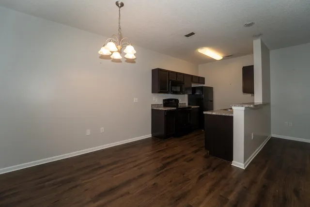 a view of a kitchen with stove microwave and refrigerator