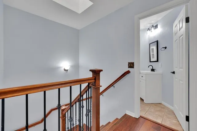 a view of a hallway with windows and stairs