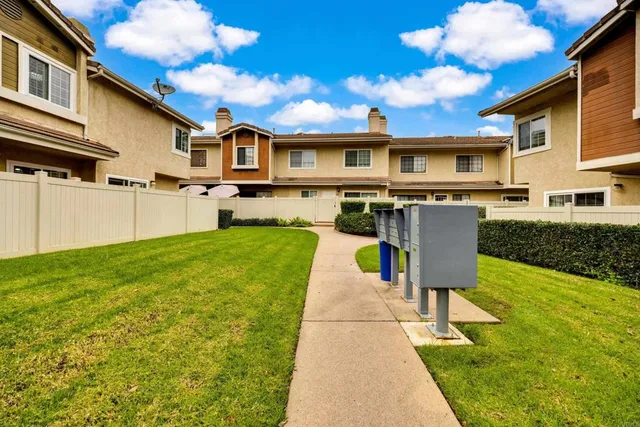 a front view of a house with a yard table and chairs