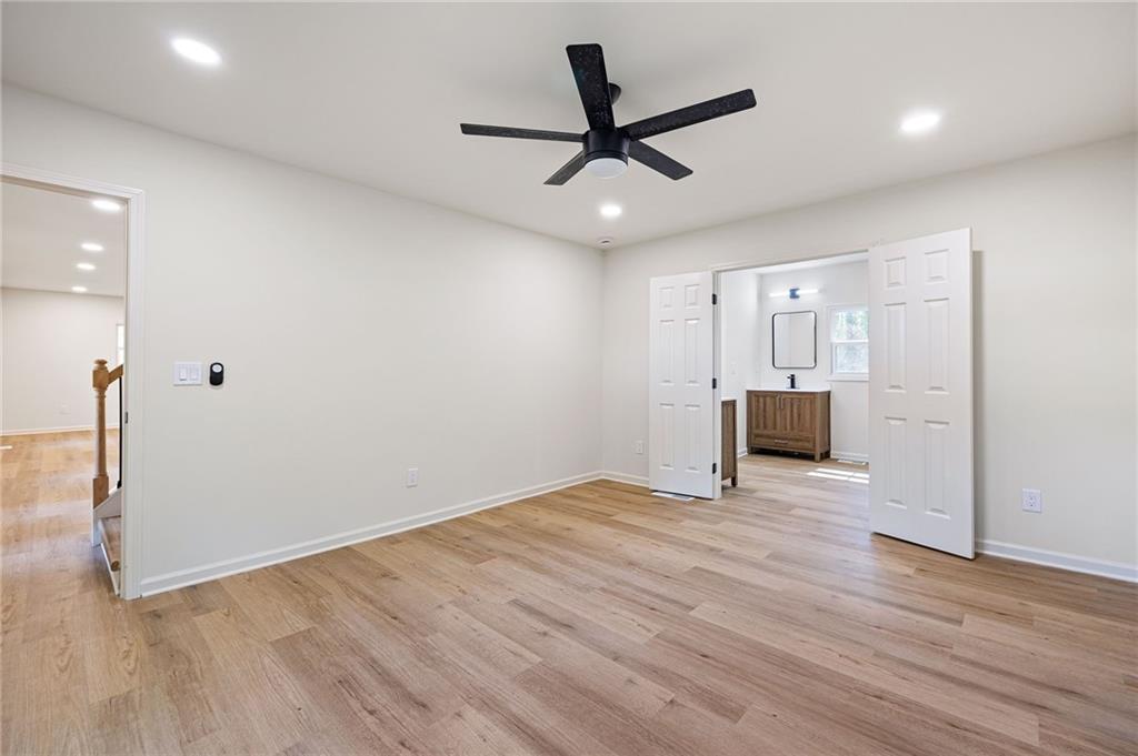 4289 Kimball Road Southwest Atlanta, GA 30331 - Photo 9 of 20 a view of empty room with wooden floor and ceiling fan