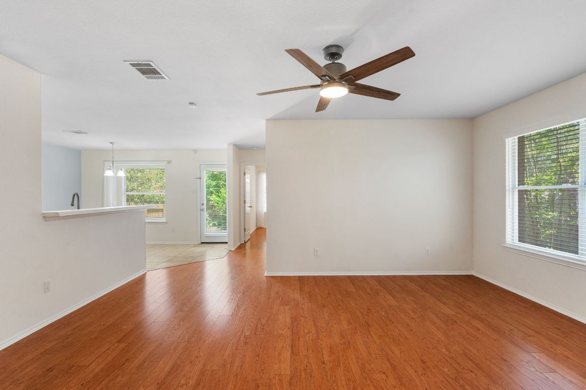 1700 Canon Yeomans Trail Austin, TX 78748 - Photo 11 of 32 a view of empty room with wooden floor and fan