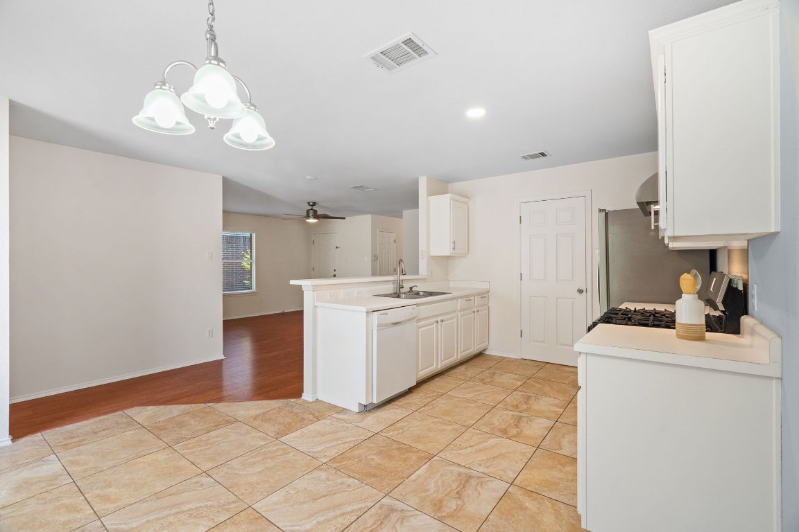 1700 Canon Yeomans Trail Austin, TX 78748 - Photo 14 of 32 a kitchen that has a sink and a stove in it