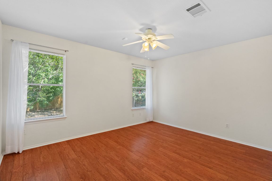 1700 Canon Yeomans Trail Austin, TX 78748 - Photo 20 of 32 a view of an empty room with a window and a ceiling fan
