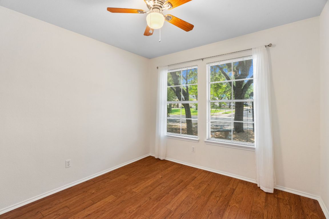 1700 Canon Yeomans Trail Austin, TX 78748 - Photo 25 of 32 an empty room with a window and a ceiling fan