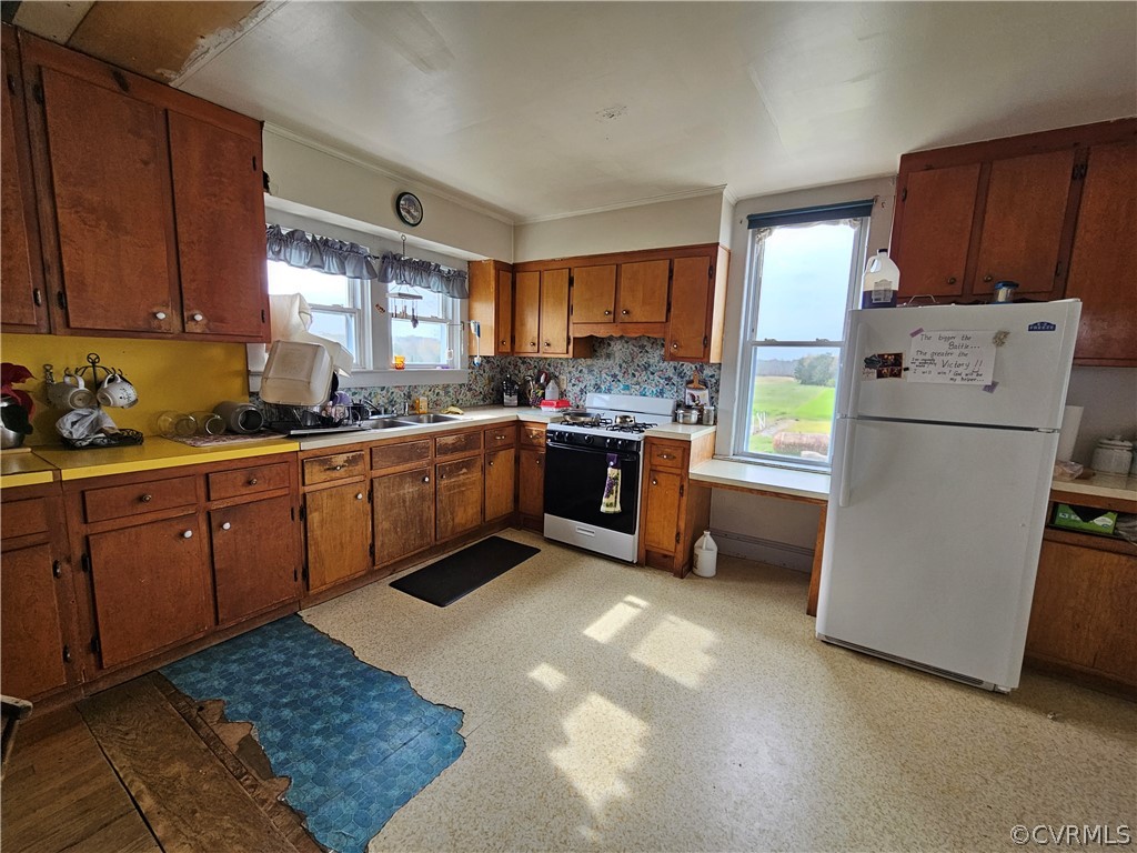 175 Raines Tavern Road Farmville, VA 23901 - Photo 29 of 46 a kitchen with sink refrigerator and cabinets