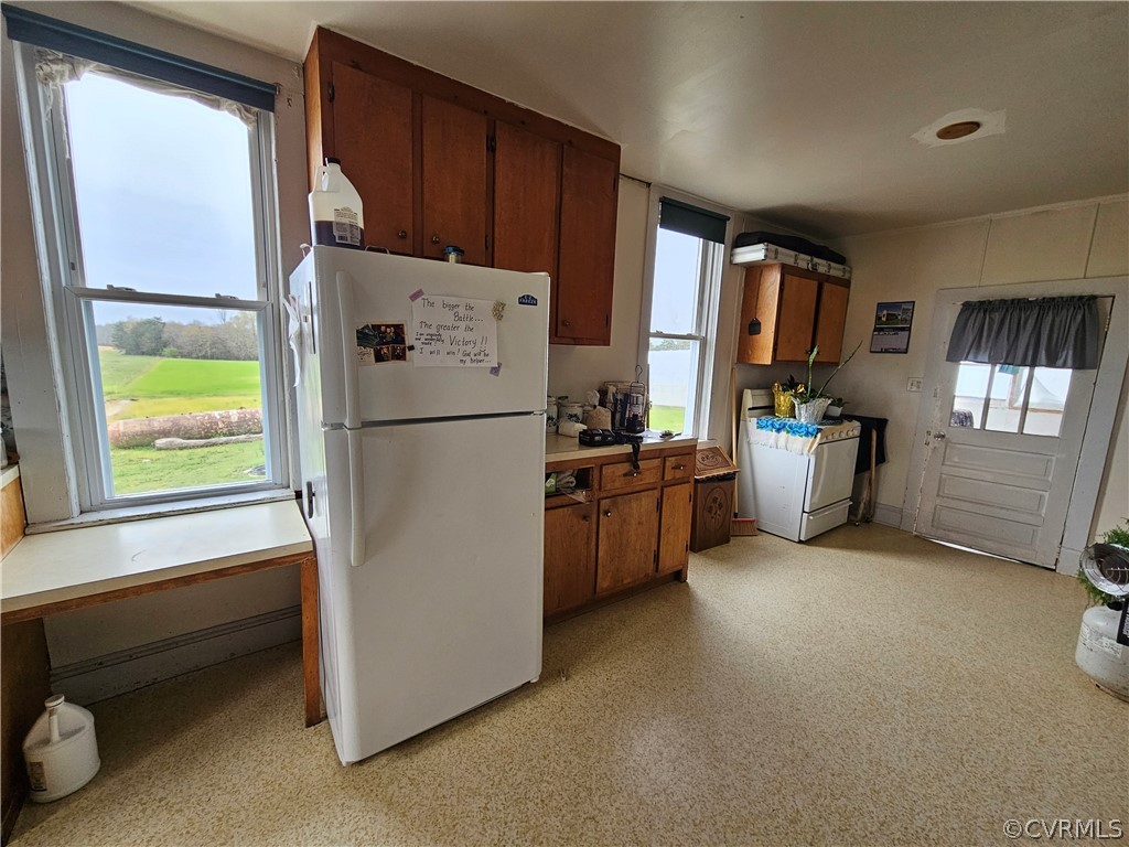 175 Raines Tavern Road Farmville, VA 23901 - Photo 30 of 46 a kitchen with refrigerator a stove a sink and a window