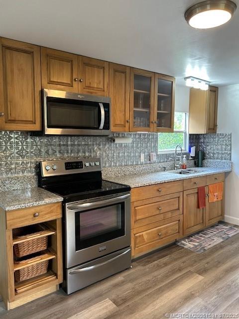 1944 Southwest College Street Stuart, FL 34997 - Photo 1 of 50 a kitchen with granite countertop wooden cabinets stainless steel appliances and a counter space