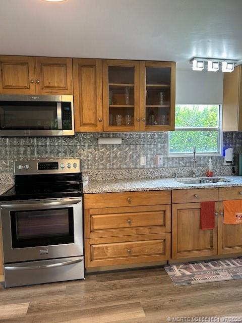 1944 Southwest College Street Stuart, FL 34997 - Photo 2 of 50 a kitchen with stainless steel appliances granite countertop a stove microwave and cabinets