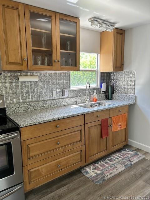 1944 Southwest College Street Stuart, FL 34997 - Photo 32 of 50 a kitchen with granite countertop cabinets sink and wooden floor