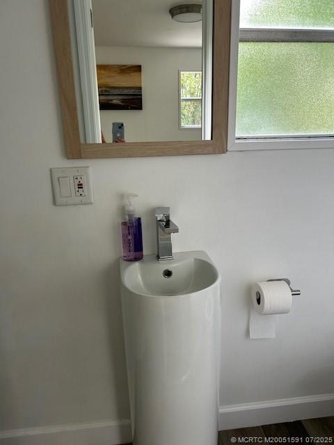 1944 Southwest College Street Stuart, FL 34997 - Photo 39 of 50 a bathroom with a sink and a mirror