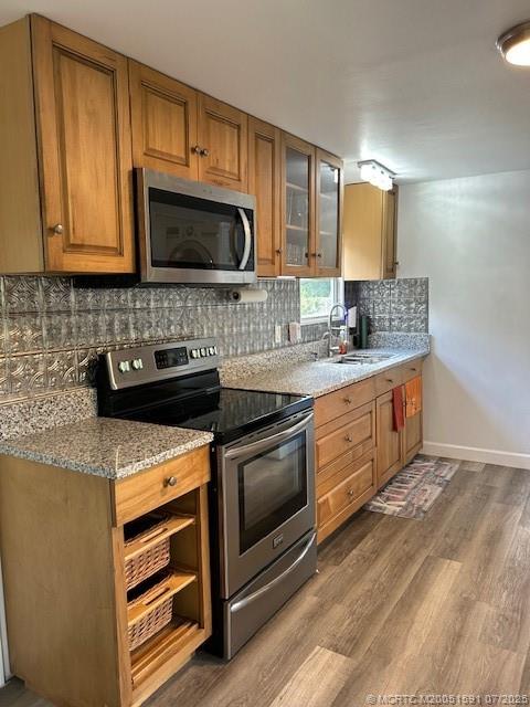 1944 Southwest College Street Stuart, FL 34997 - Photo 4 of 50 a kitchen with stainless steel appliances granite countertop a sink stove and microwave