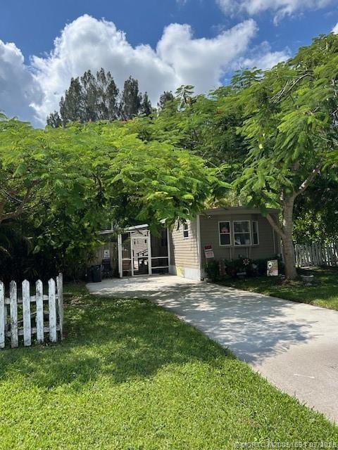 1944 Southwest College Street Stuart, FL 34997 - Photo 45 of 50 a front view of a house with a garden