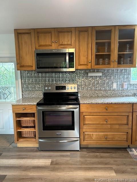 1944 Southwest College Street Stuart, FL 34997 - Photo 5 of 50 a kitchen with granite countertop a stove microwave and oven