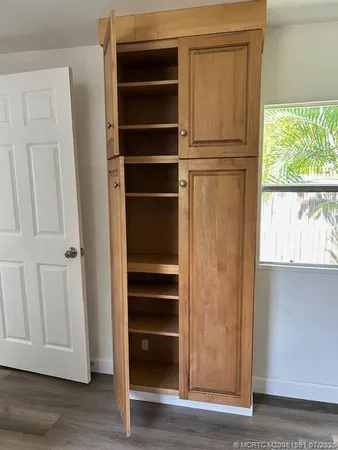 a view of walk in closet with empty racks