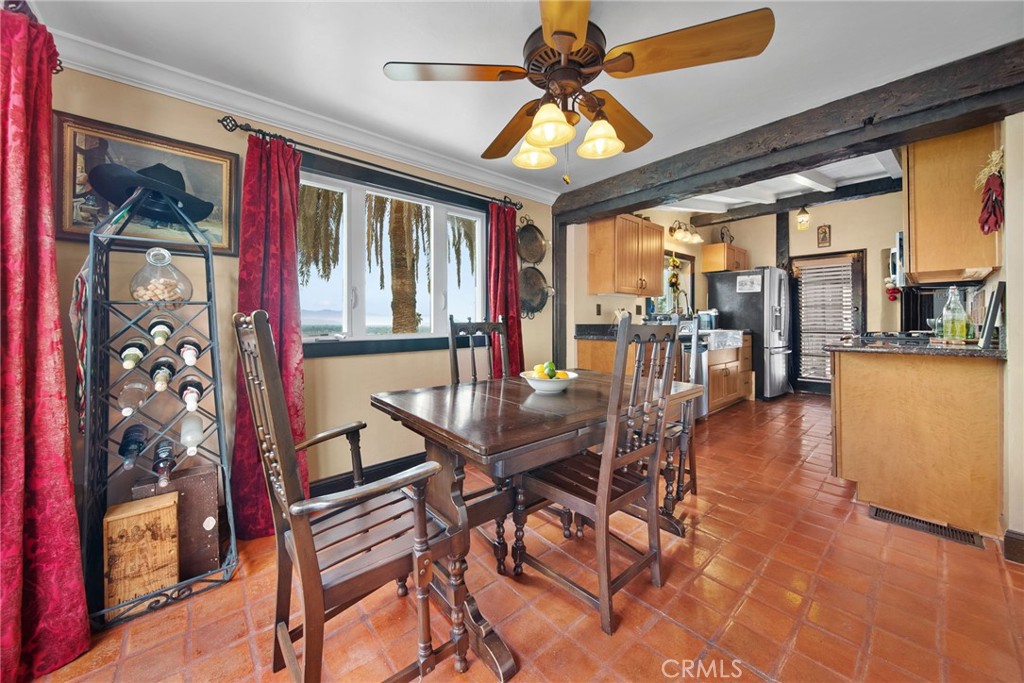 3240 Pachappa Hill Riverside, CA 92506 - Photo 33 of 75 a dining room with furniture a chandelier and wooden floor