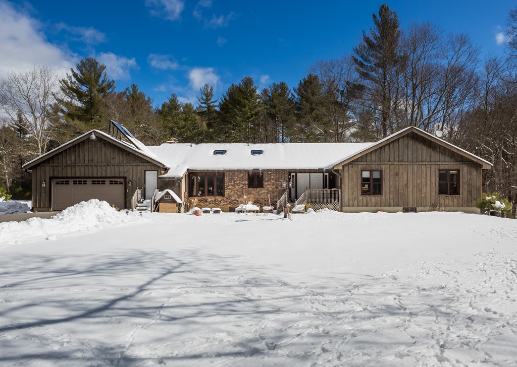 125 Bennett Road Hampden, MA 01036 - Photo 1 of 23 a front view of a house with a yard covered in snow