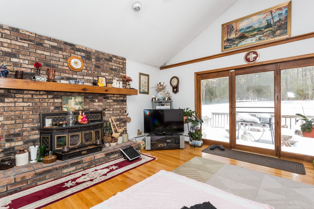 125 Bennett Road Hampden, MA 01036 - Photo 12 of 23 a living room with fireplace furniture and a flat screen tv