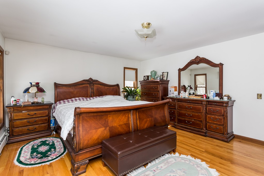 125 Bennett Road Hampden, MA 01036 - Photo 18 of 23 a bedroom with a bed and a chandelier