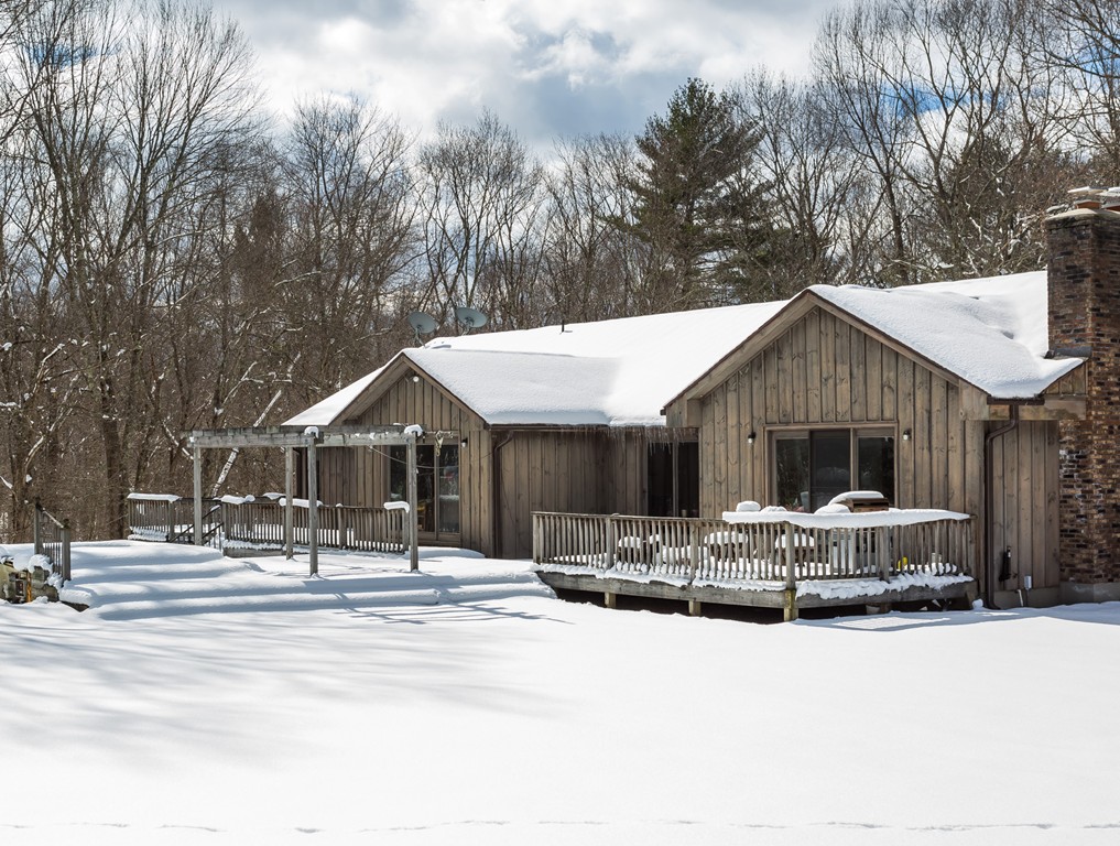 125 Bennett Road Hampden, MA 01036 - Photo 6 of 23 a front view of a house with a yard covered with snow and trees