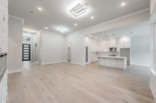 a kitchen with kitchen island granite countertop a sink stainless steel appliances and cabinets