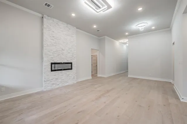 a kitchen with stainless steel appliances granite countertop a sink a stove a refrigerator a center island and cabinets