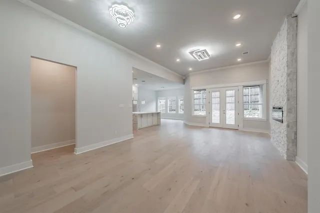 a kitchen with white cabinets and window