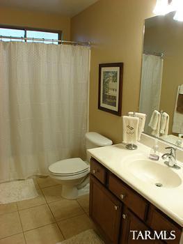 62195 East Northwood Road Tucson, AZ 85739 - Photo 21 of 25 a bathroom with a sink and a mirror