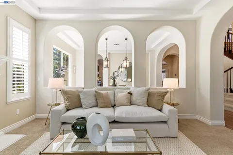 a living room with furniture a fireplace and a large window with wooden floor