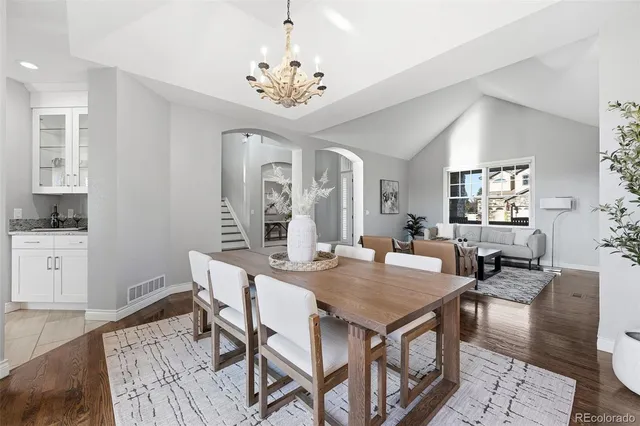 a kitchen with cabinets a counter and chairs